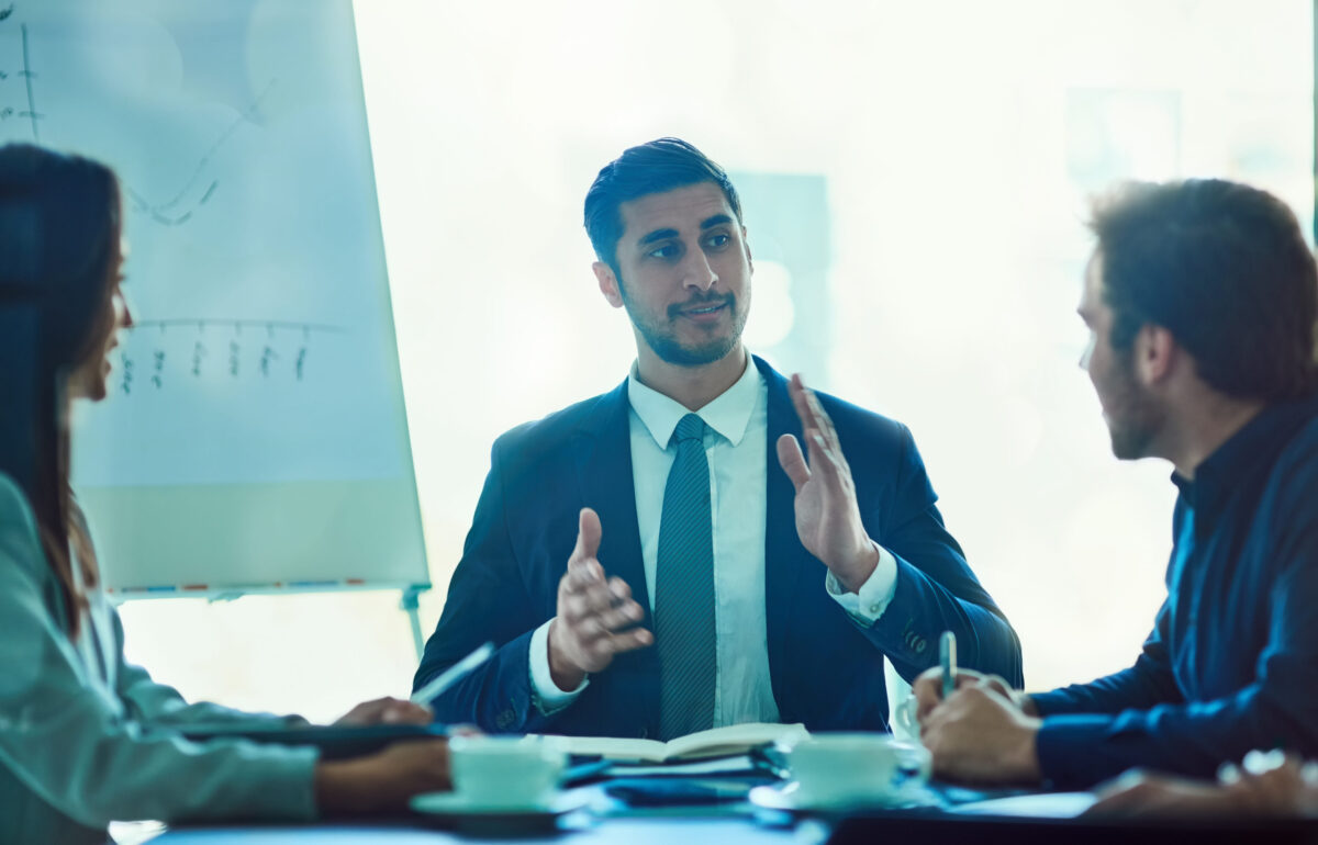 Owning the boardroom. Shot of a young executive talking during a meeting with colleagues in a boardoom.