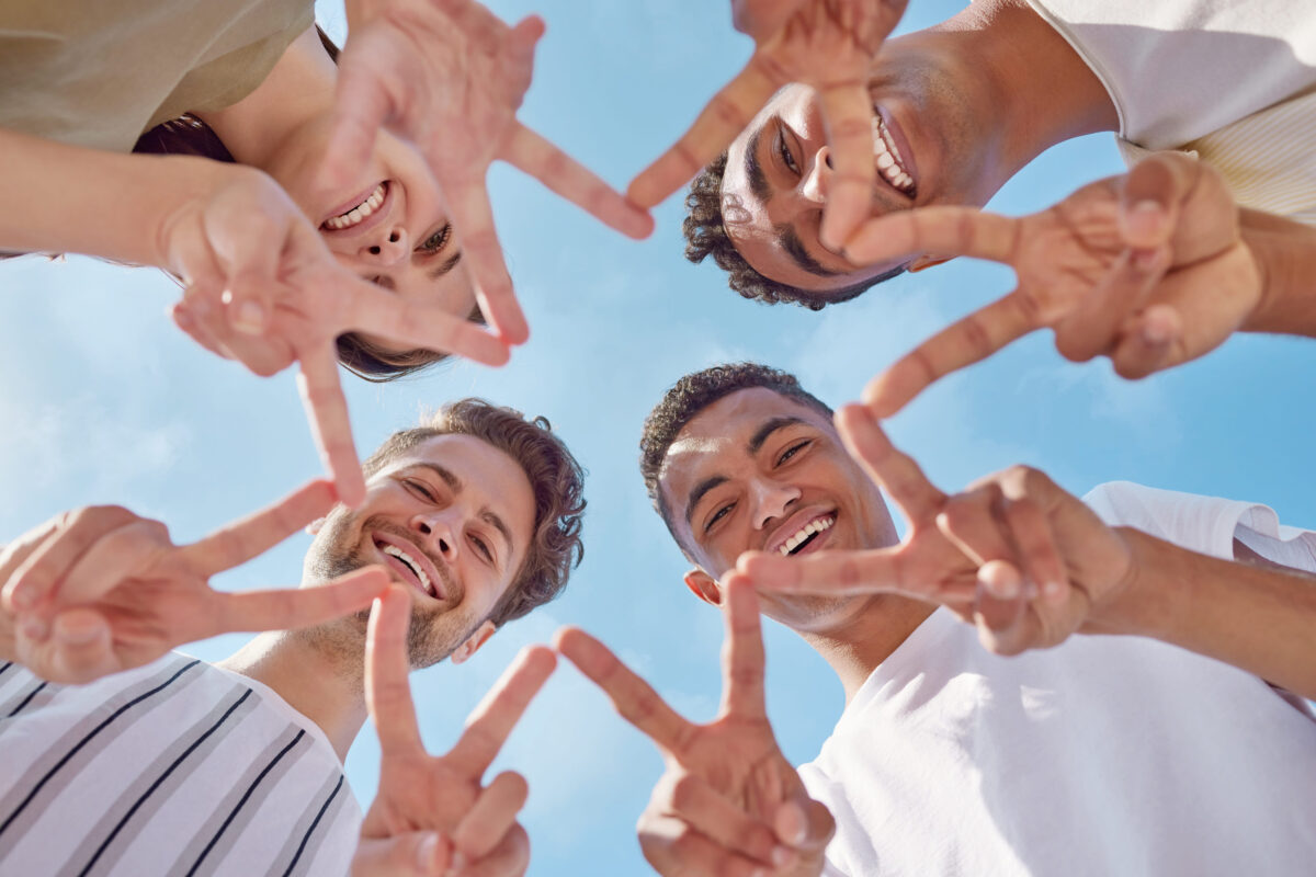 You shine brighter than a star. Shot of a group of young friends making a star shape with their hands outside.