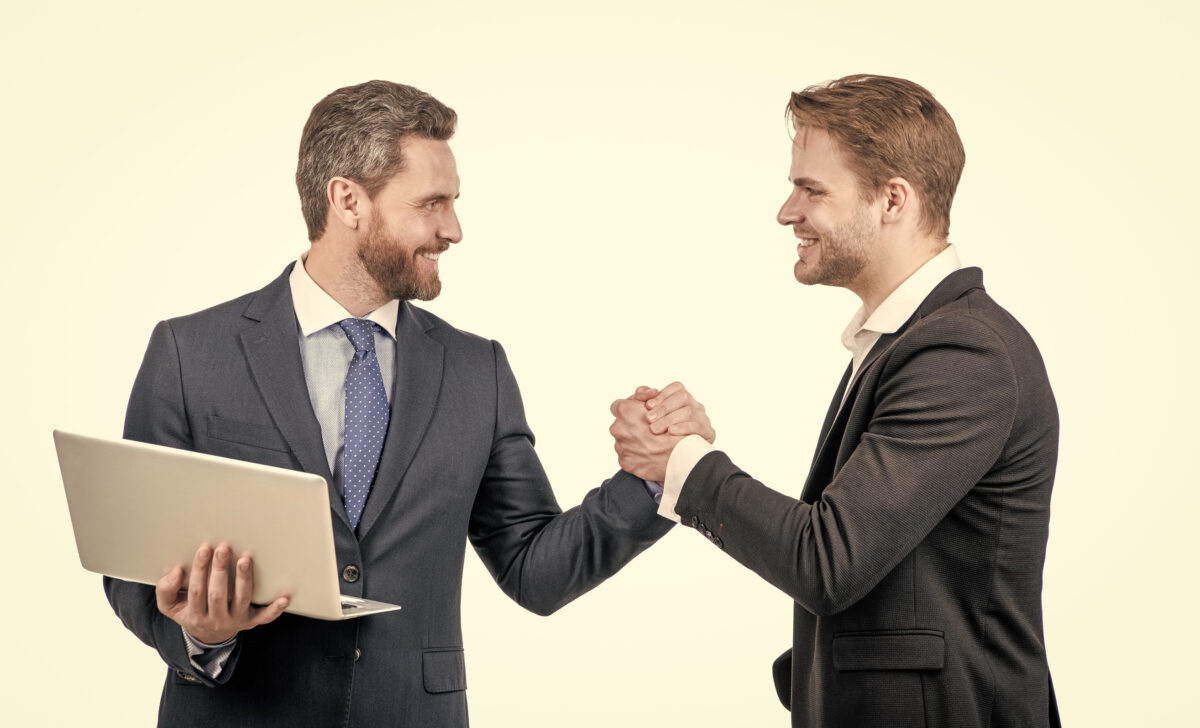 7 Harsh Rules Emotionally Unavailable Men Live By 3 businessmen with laptop on meeting. boss and employee. partners after business deal.