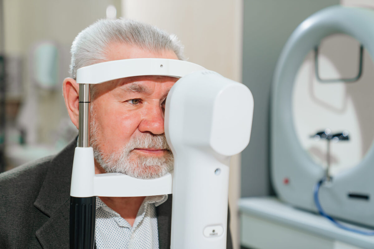 examination of elderly man on corneo topographer.modern clinic