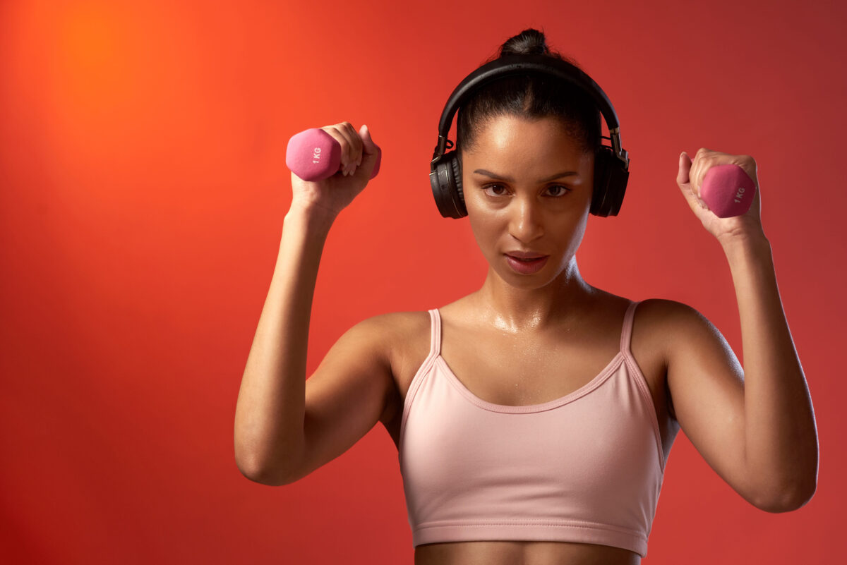11 Common Pitfalls That Prevent People From Getting In Shape 2 You earn it through a lot of hard work. Studio portrait of a sporty young woman exercising with dumbbells against a red background.