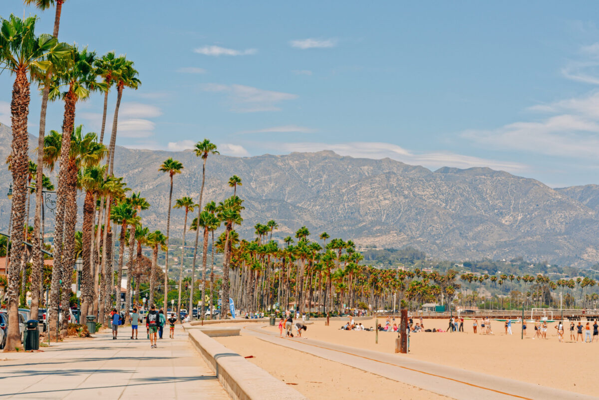 8 Worst States If You Want To Take Vacations More Often in 2026 2 Santa Barbara, California, USA - August 1, 2022 Santa Barbara beach promenade with walking people, sandy beach, and mountains and cloudy sky on background