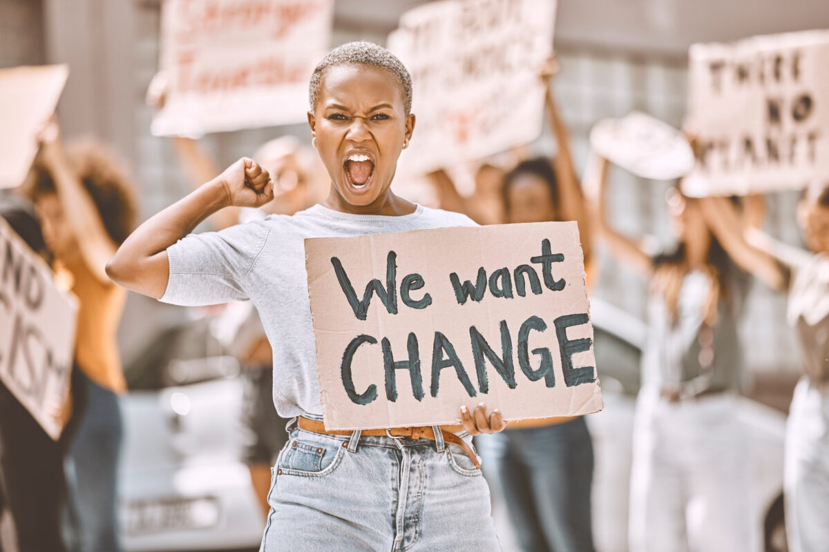 Republican Loyalty Is Starting to Crack as Voters Eye Independent Candidates, Polling Shows 4 Woman, angry protest and banner in city street for freedom, peace and social diversity. Young black girl, people walk in protesting rally together and community collaboration for feminist empowerment