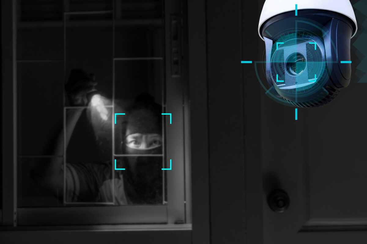 CCTV Camera Showing A Burglar Stealing Things In The House.Smart home security camera on the wall.Cameras work day and night,video recording in the dark.Protection from thieves and vandals.