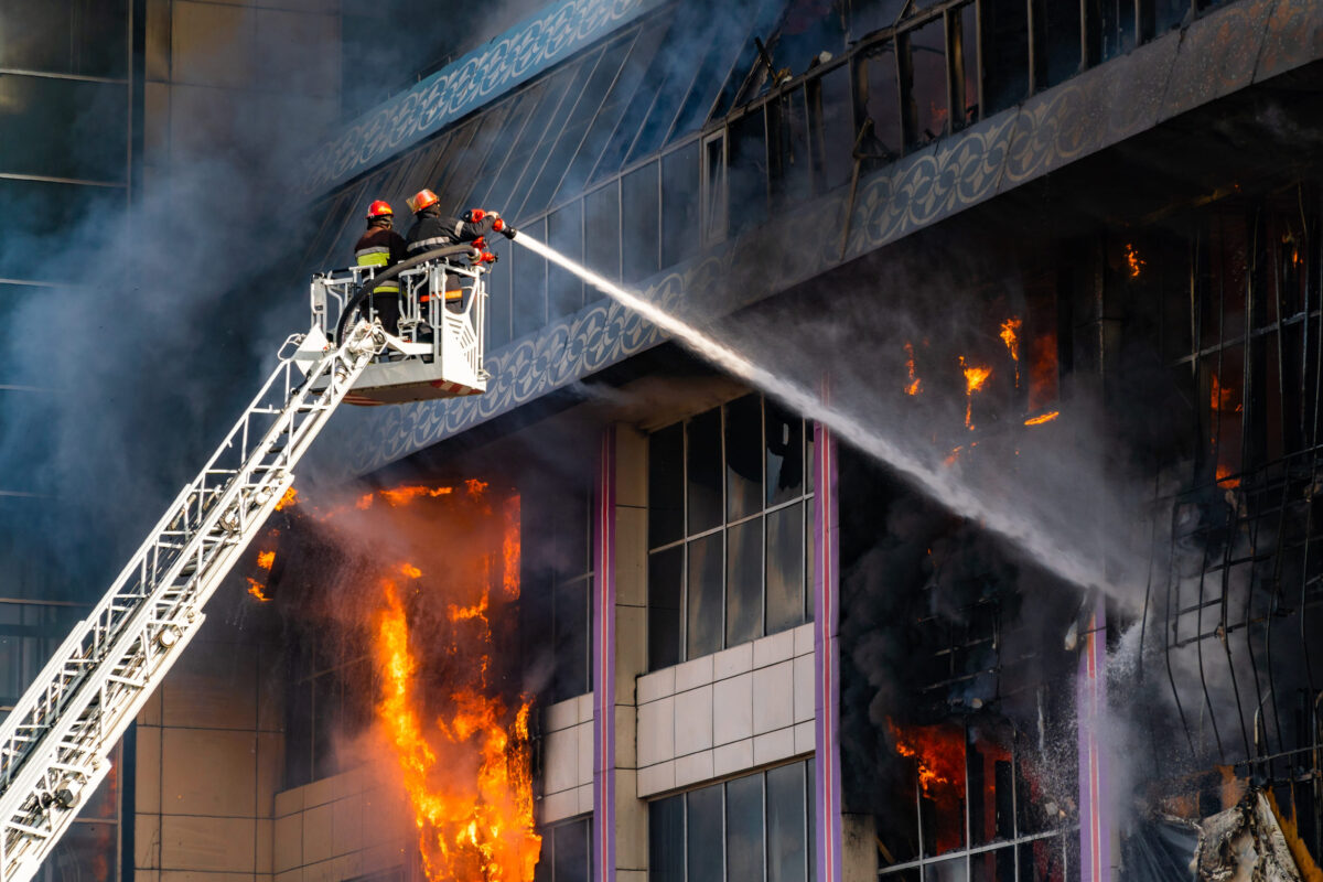 Firefighters on the stairs extinguish a big fire