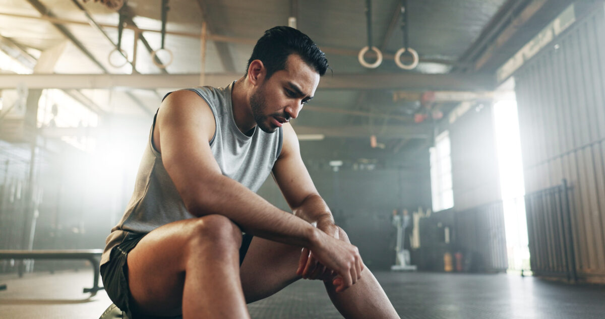 11 Common Pitfalls That Prevent People From Getting In Shape 5 Fitness, breathing and sweating with a tired man in the gym, resting after an intense workout. Exercise, health and fatigue with a young athlete in recovery from training for sports or wellness