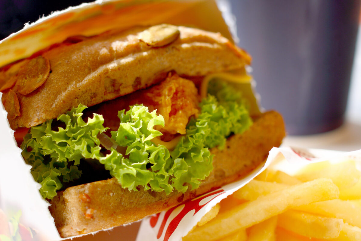 8 Unhealthiest Fast-Food Chicken Sandwiches, Ranked 1 Sandwich with chicken vegetable chips and orange juice. A fragment of a menu of fast-food restaurant.