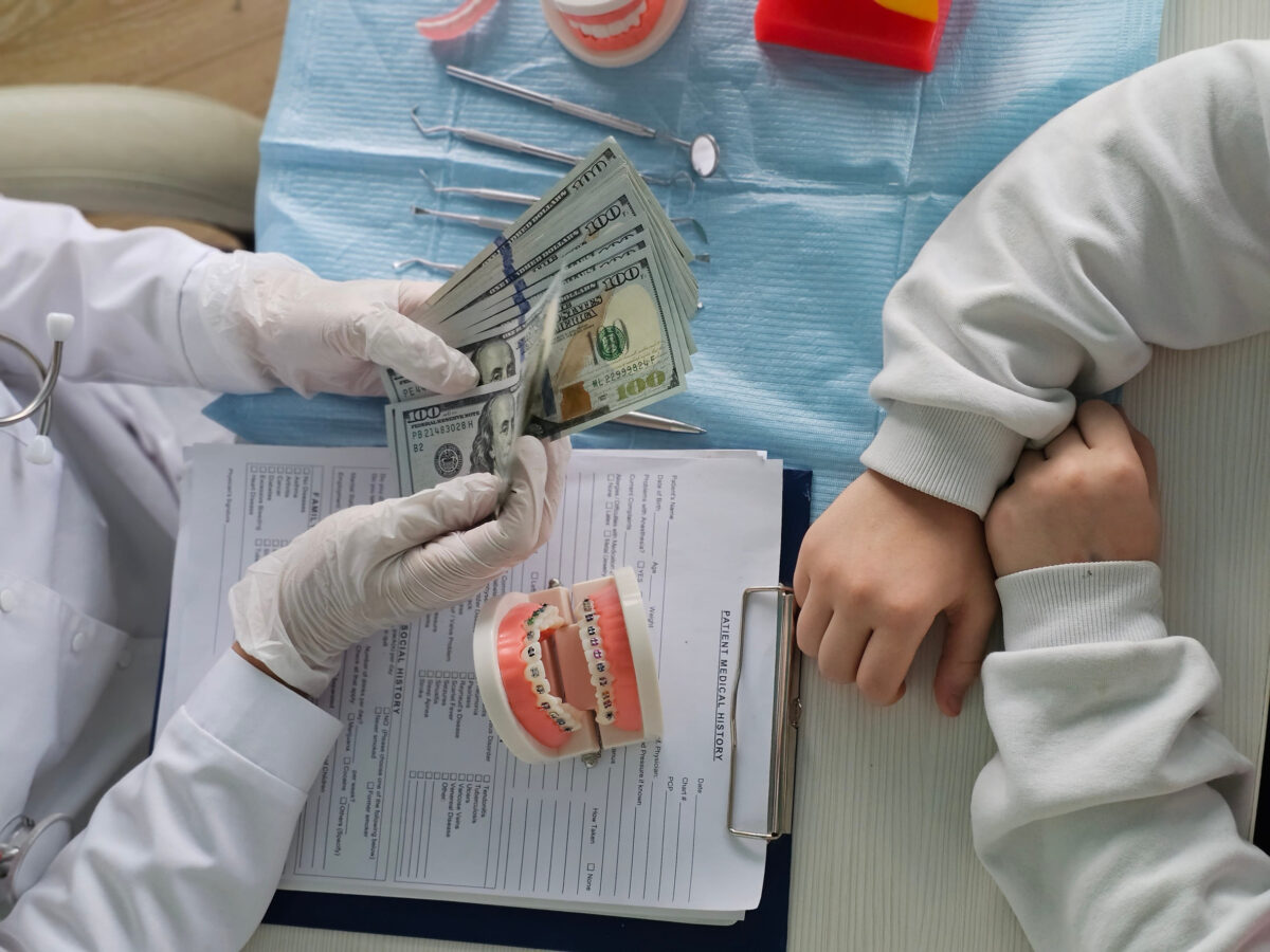 The patient consults with the doctor about the cost of dental braces dental treatment and payment options during the doctor visit