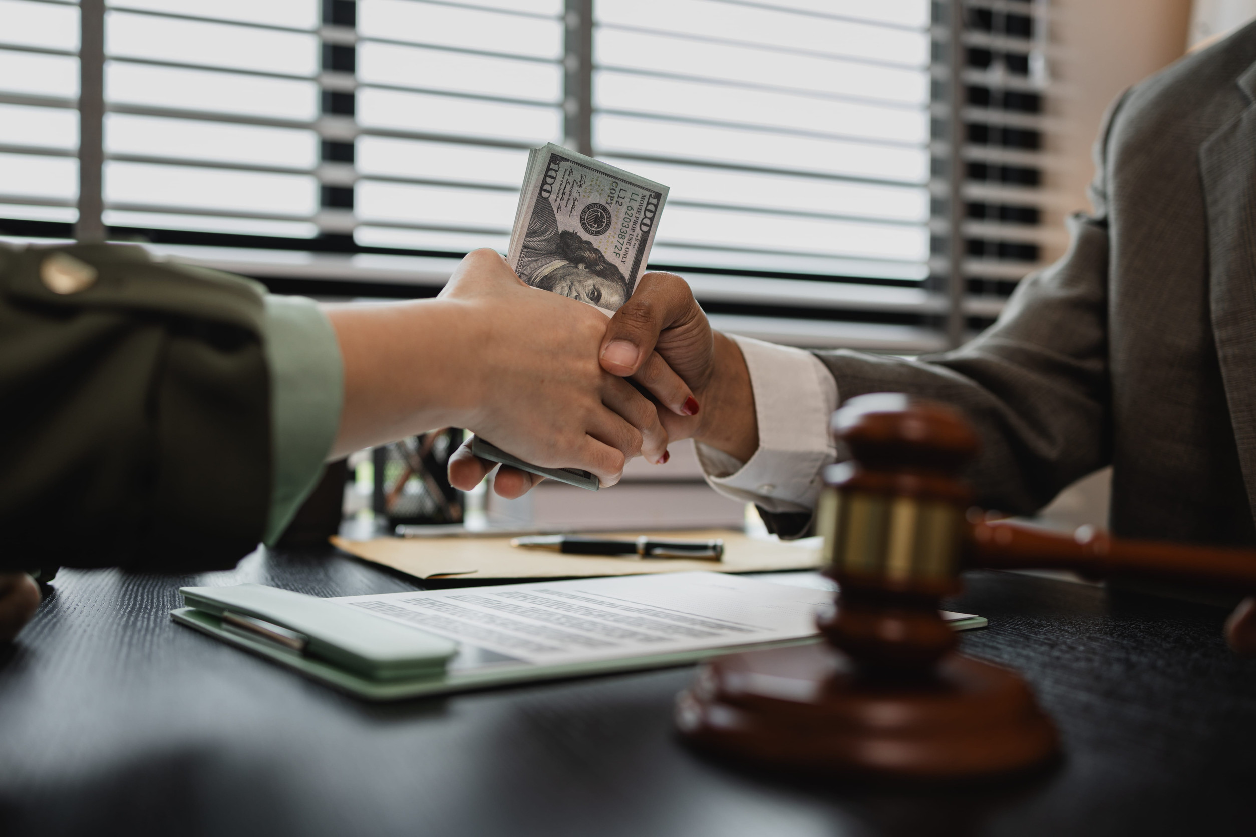 8 Ways Trump’s Citizenship Fee Plan Could Change the Meaning of the American Dream 1 lawyer and client shake hands after receiving money, a client is giving money to the opposing lawyer in order to win a case