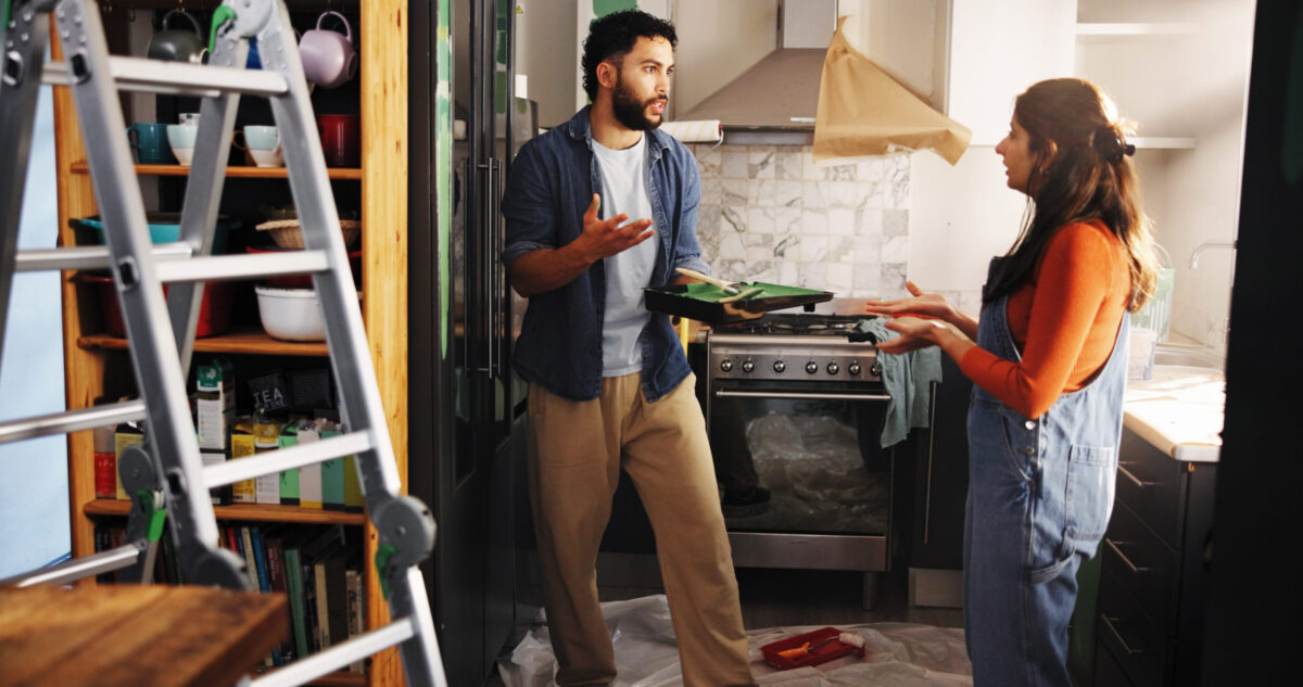 Home improvement, argument and couple with paint, kitchen and fight for color of apartment or decor. Angry, black man and woman with conflict in new house, disagreement and discussion for remodeling