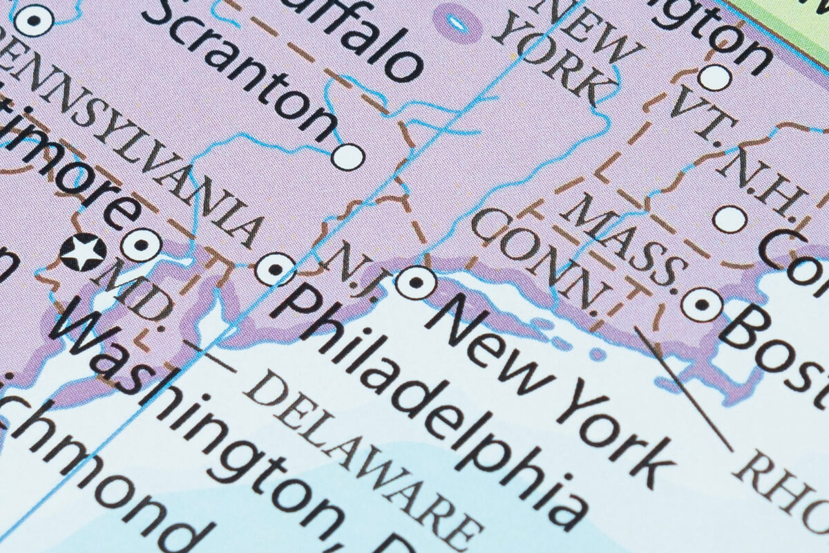Macro photography of New York city into political United States of America map with important cities