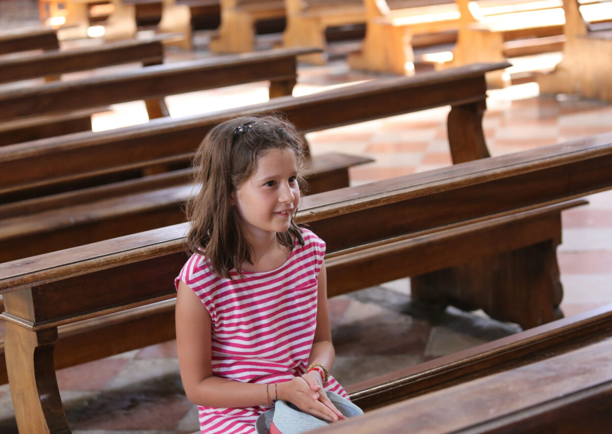 American Churches Face a Brutal Truth as Millions Drift Away From Organized Religion 2 pretty little girl on Pew in the church during a prayer