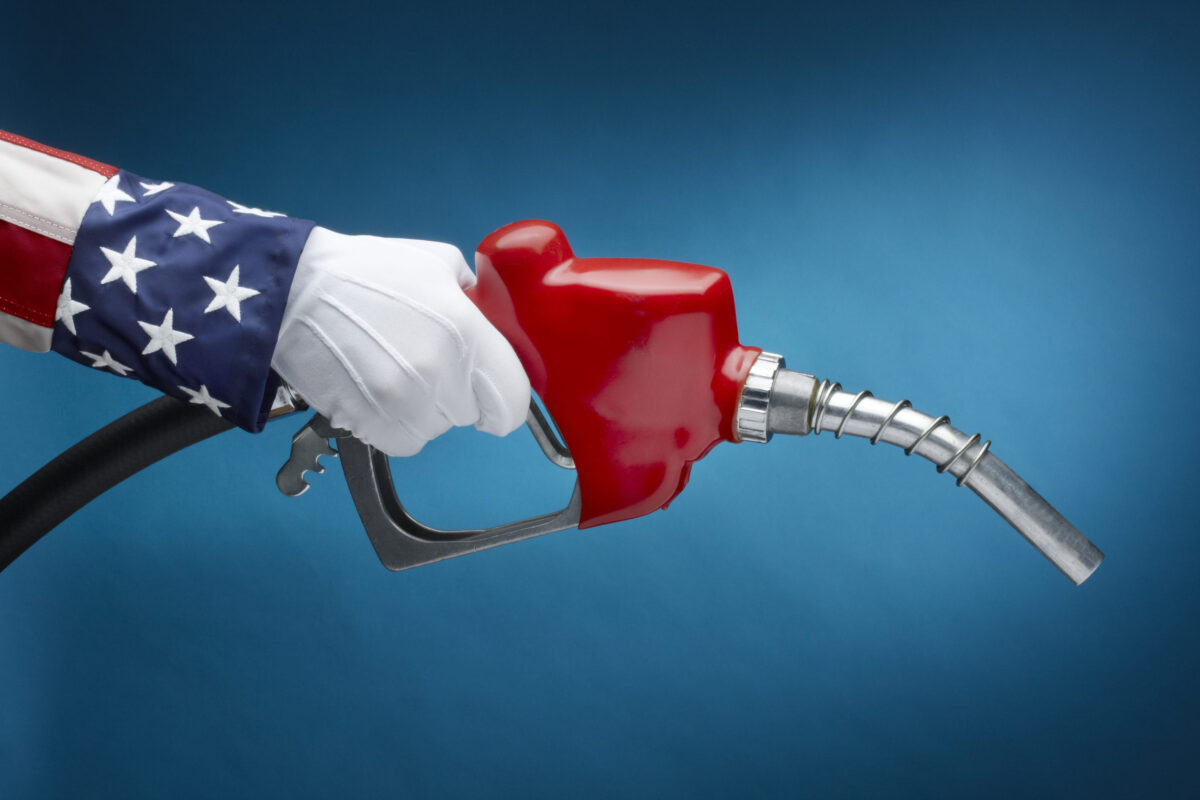 Close up shot of Uncle Sam holding gas nozzle with space for copy