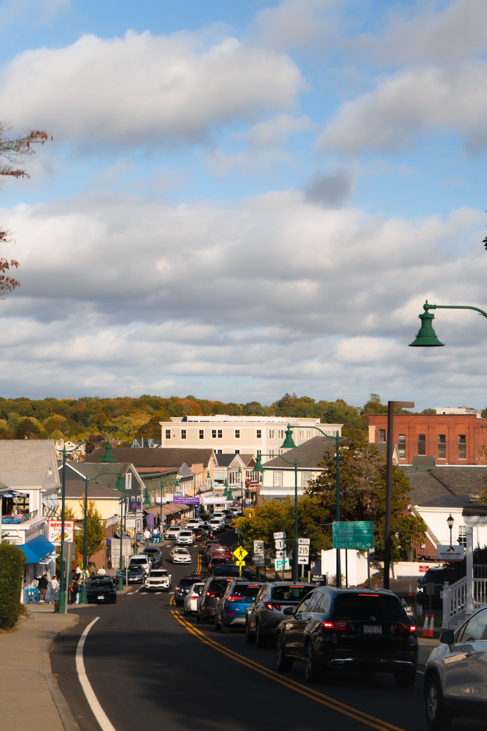 15 States Where Medical Bills Bite The Hardest on Your Income 2 A bustling small town street with autumn foliage and traffic under a cloudy sky.