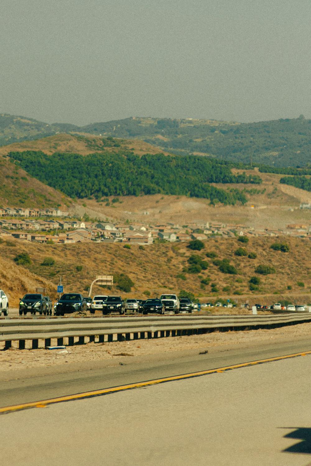 The Next Quake in California Could Be Catastrophic… Here’s Why 3 A busy highway with vehicles against a mountain backdrop in San Diego, California.