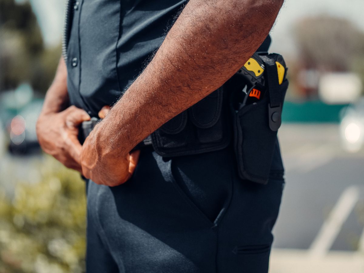 Axon Stock, Trump Trades, and ICE Contracts: A Market Story Driven by Timing, Trust, and Perception 1 A close-up view of a police officer's uniform and equipment. Focus on belt and hands.