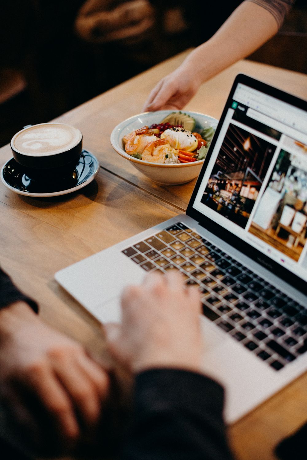 10 Small Business Website Examples That Show What High-Performing Websites Do Right 3 A contemporary workspace with a laptop, coffee, and a bowl of soup, ideal for remote work settings.
