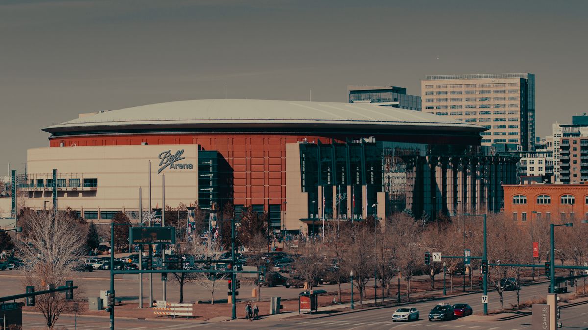 9 U.S. Cities Where Rising Heat Is Turning Daily Life Into a Nightmare 4 A daylight view of Ball Arena amidst Denver's urban landscape, highlighting its architectural design.