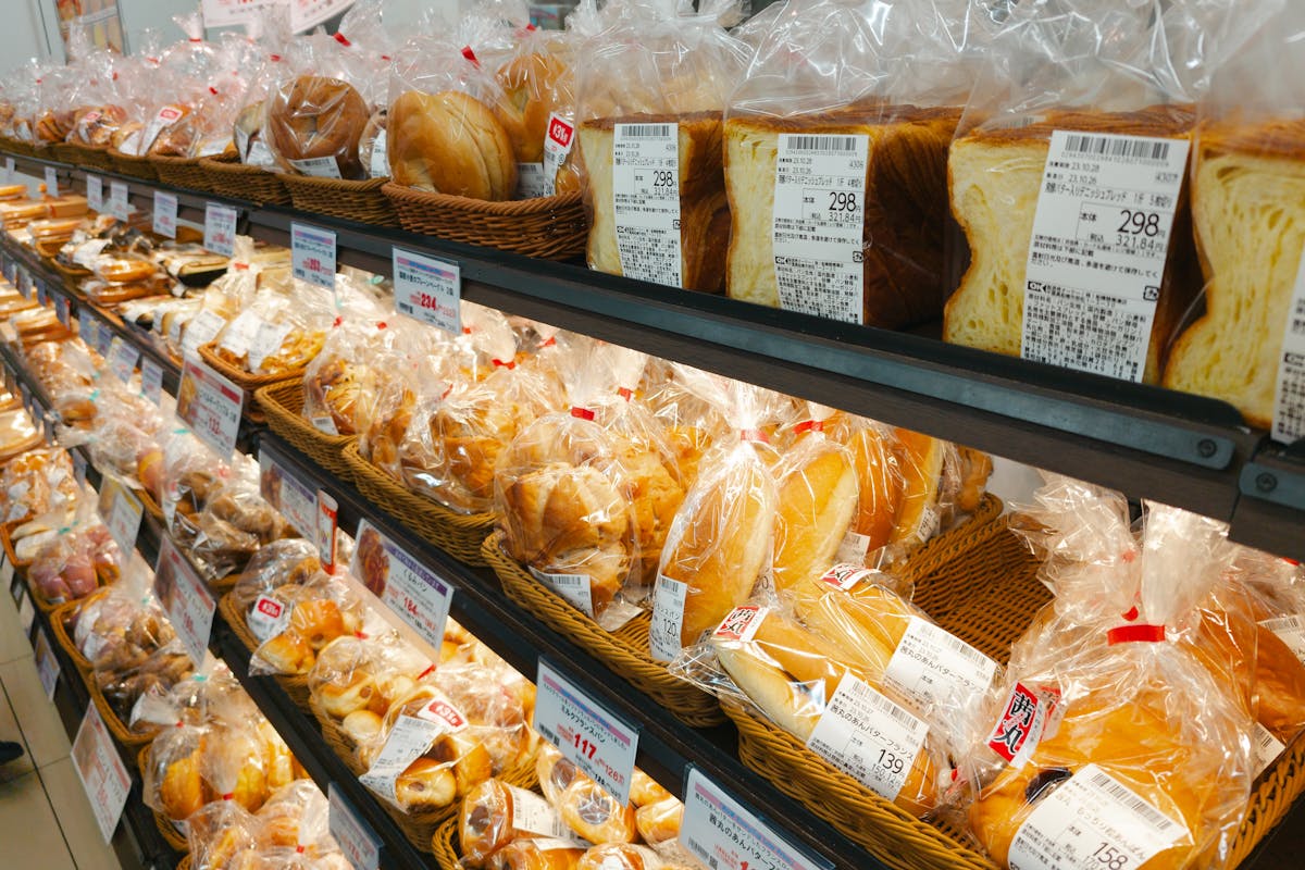 8 American Foods That Are Banned or Restricted in Other Countries 1 A diverse selection of prepackaged bread in a grocery store aisle, perfect for food-related projects.