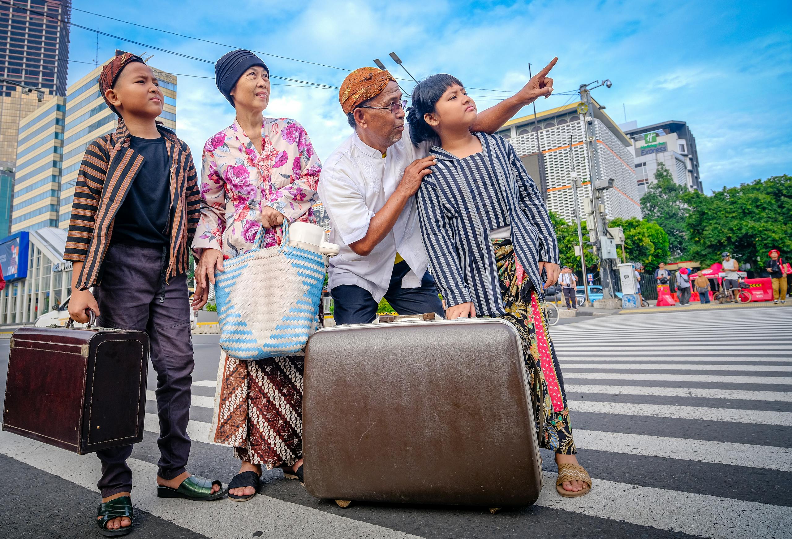 9 boomer travel habits that can drain the fun out of any trip 1 A family in traditional Javanese clothing crosses a street in Jakarta, suggesting a cultural journey.