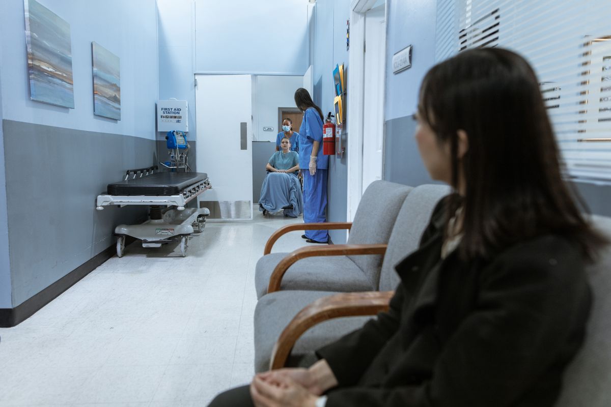 U.S. Economy Loses 23,000 Jobs in July as Labor Market Shows New Signs of Weakness 2 A hospital scene showing patients and medical staff in a corridor, illustrating healthcare environments.