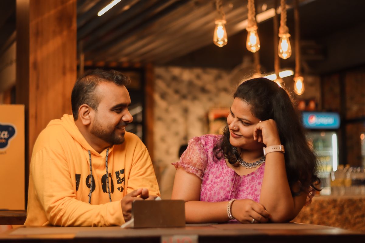 8 First-Date Questions Women Secretly Wish More Men Would Ask in 2026 3 A joyful couple sharing a moment at a cozy indoor setting. Perfect for lifestyle themes.