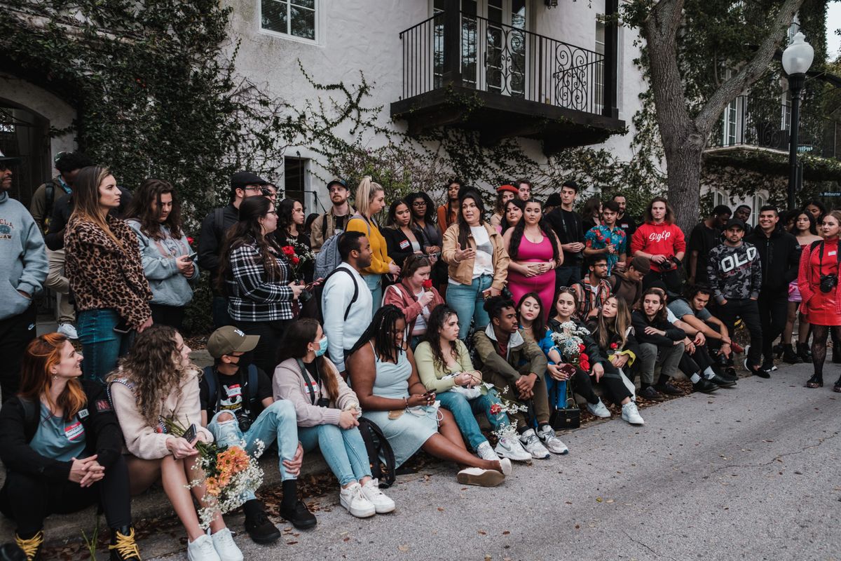 A large group of diverse people gathered outdoors in Winter Park, FL, showcasing community and togetherness.