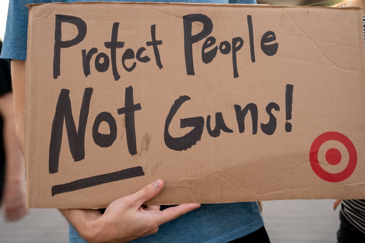 A protest sign in New York advocating for gun control and safety.