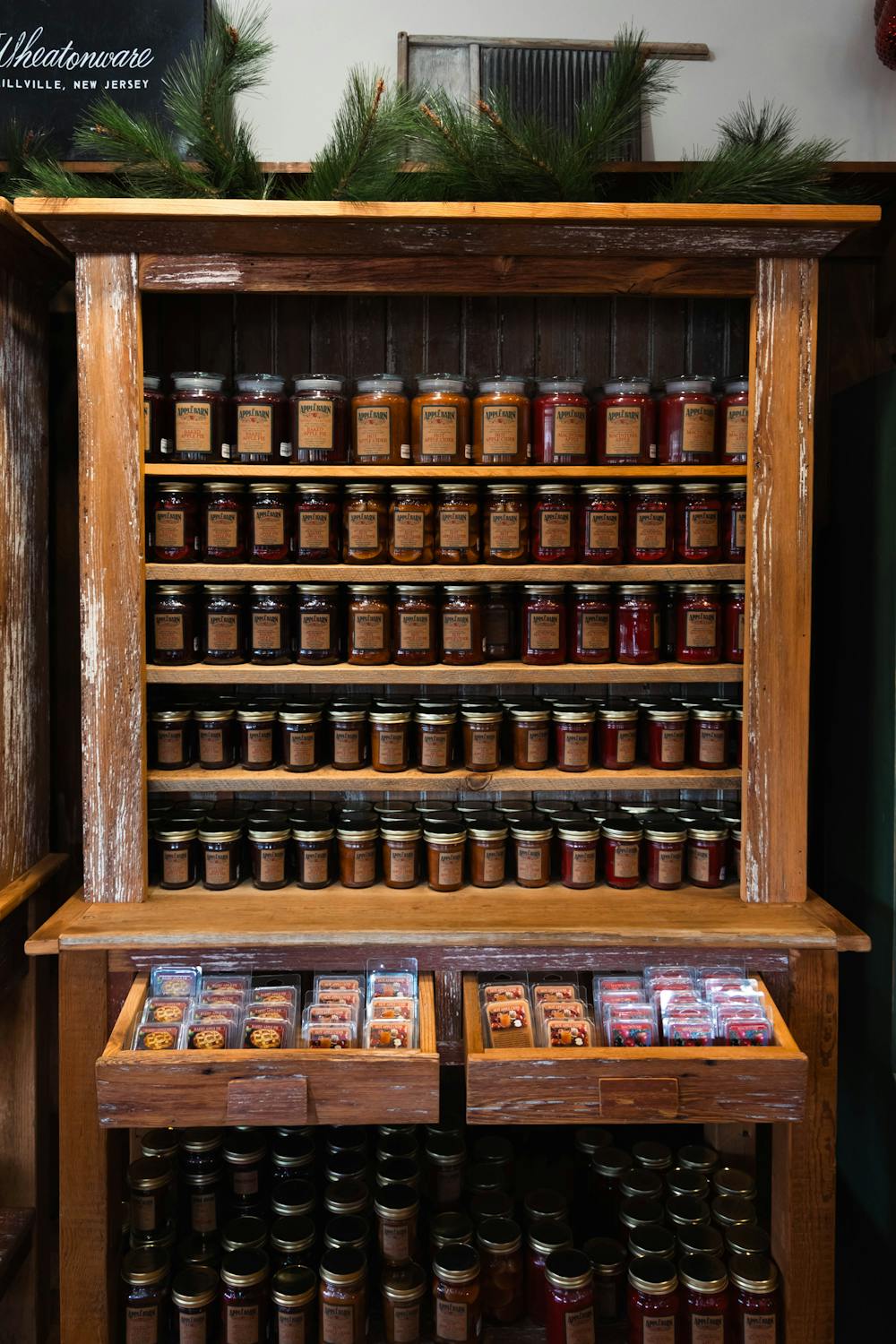A rustic wooden spice rack filled with various spice jars in Millville, New Jersey.