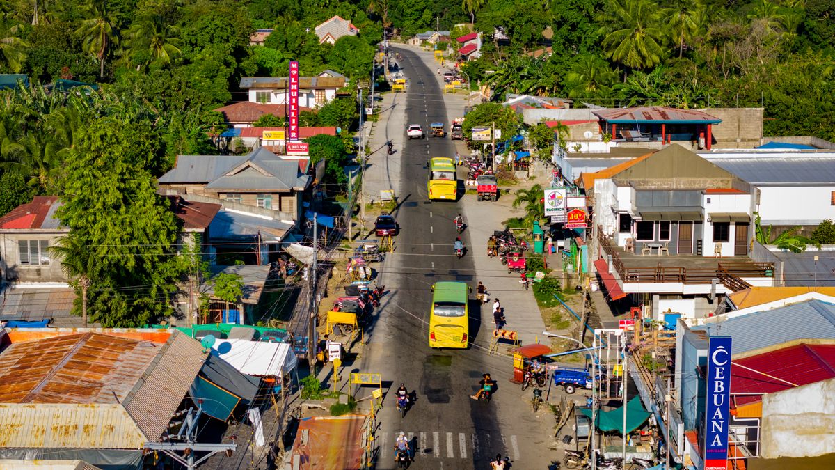 A vibrant aerial view of Bacong, Philippines, showcasing busy streets and lush greenery.