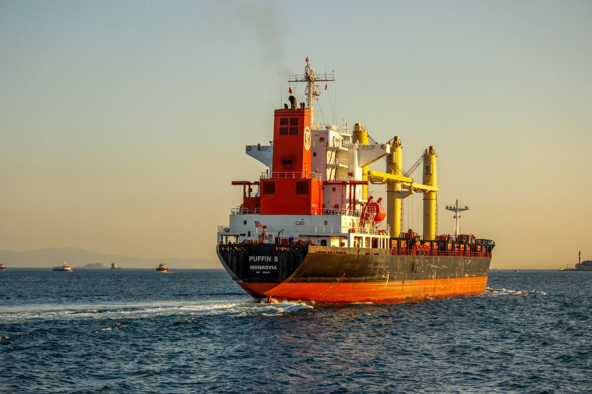 A vibrant container ship navigating the Bosphorus Strait, Istanbul during sunset, enhancing the maritime scenery.