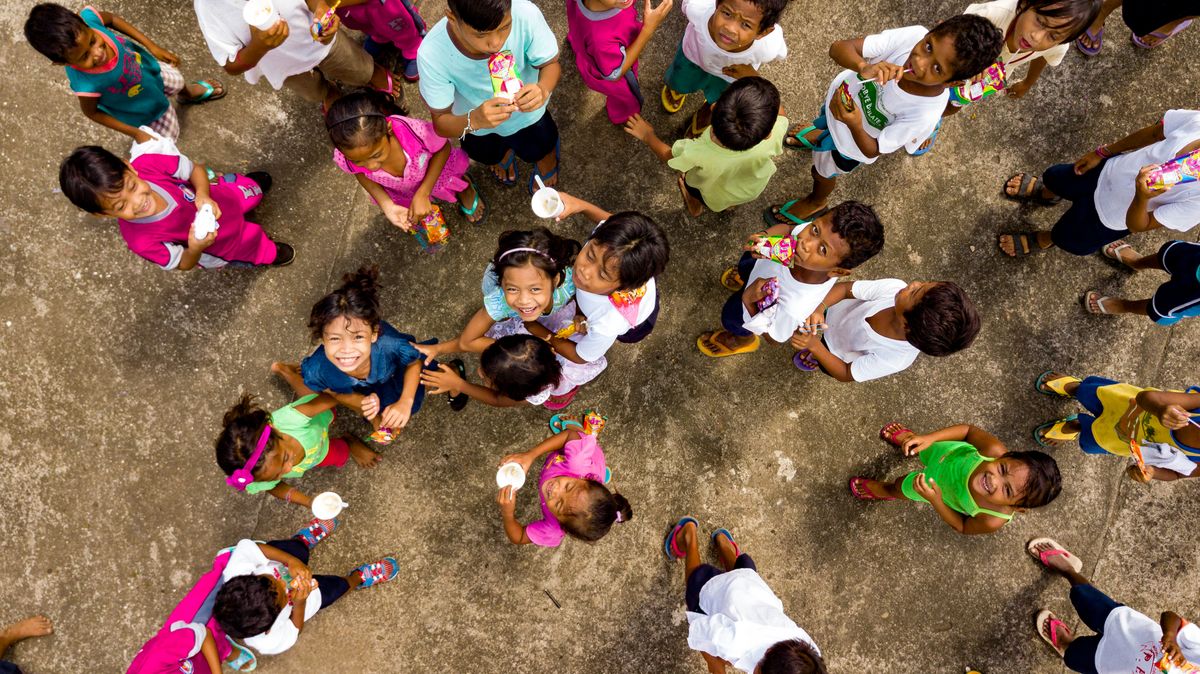 Elon Musk, DOGE, and USAID Cuts: Ro Khanna’s Push for Accountability Over Global Aid Fallout 2 A vibrant top view of cheerful children gathered on pavement, smiling and socializing.