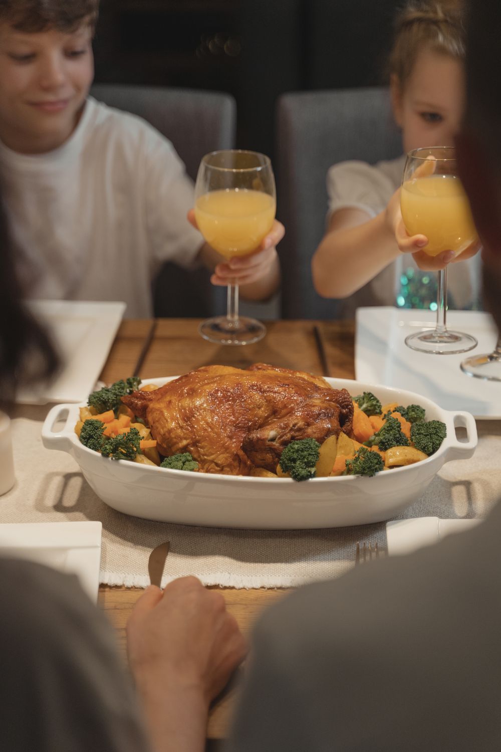 America Is Losing More Than Time in Traffic, and the New INRIX Scorecard Shows How Bad It Has Become 3 A warm family gathering around a table with roasted turkey and orange juice, celebrating a festive meal indoors.