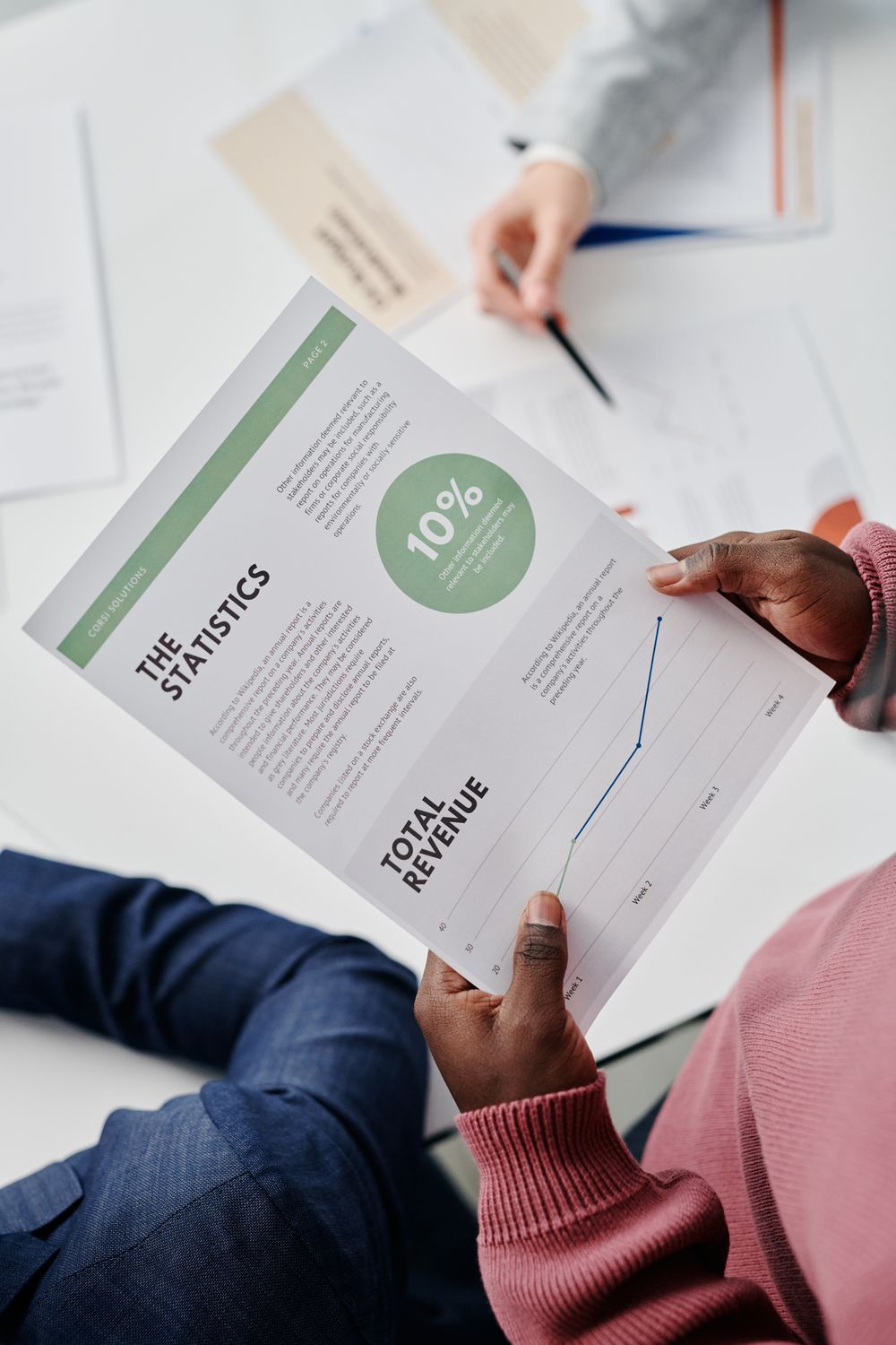 Going Global Can Grow a Business Fast. It Can Also Expose Every Weak Spot. 2 Adults reviewing statistical business reports in a professional office environment.