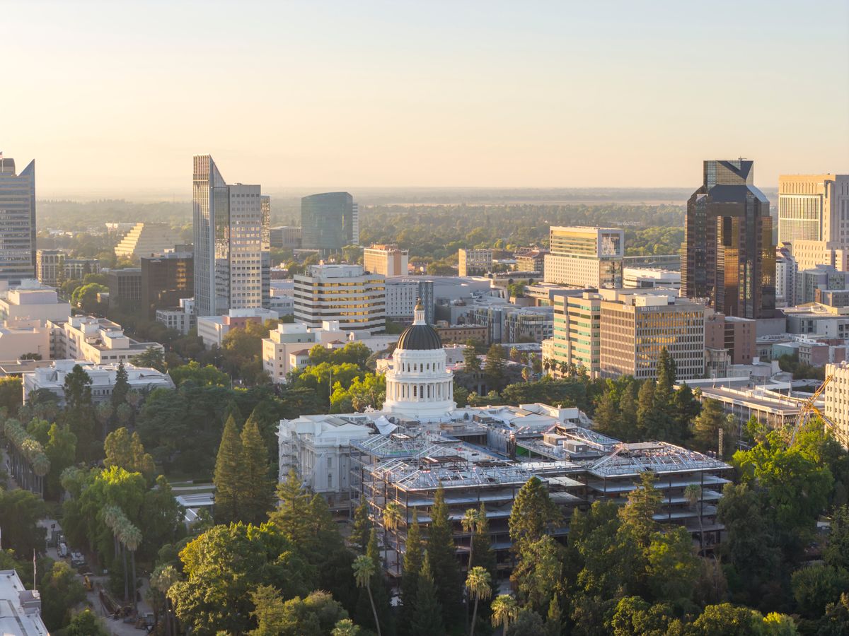 Aerial view of Sacramento cityscape featuring the California State Capitol at sunset.