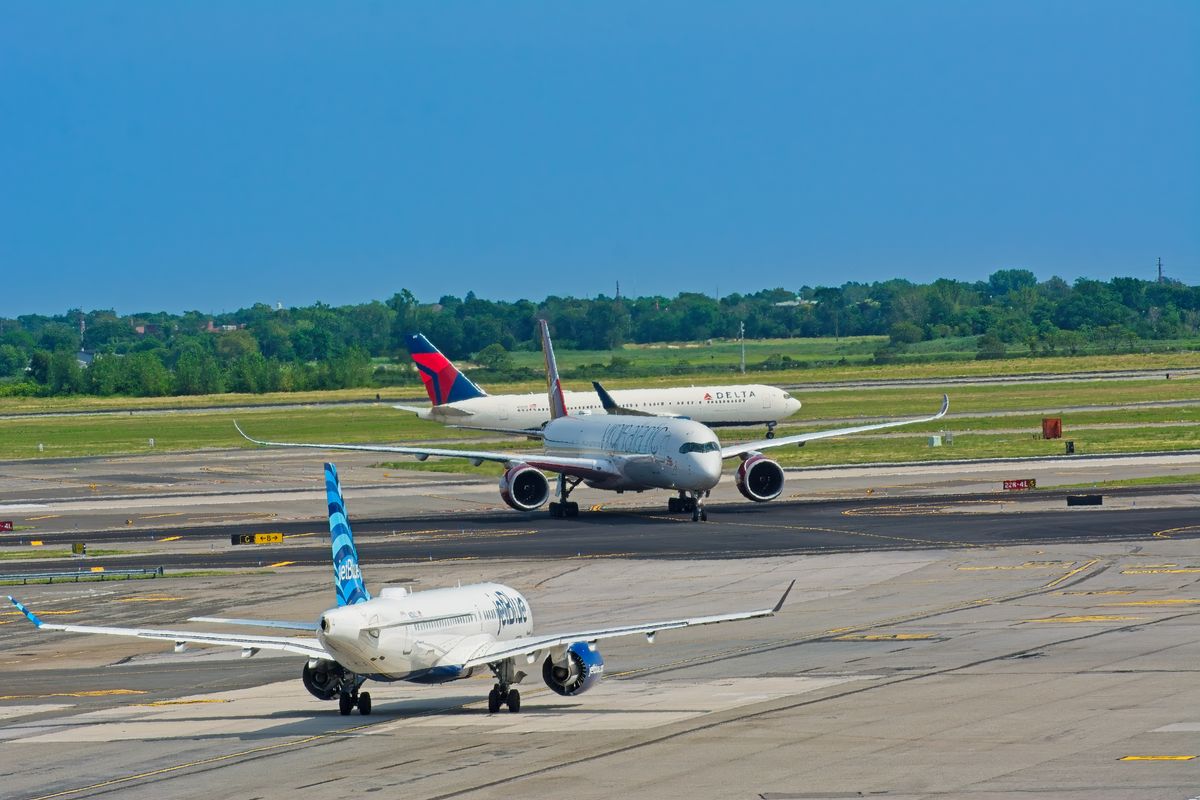 WestJet Strike Leaves Thousands in Limbo as Canada’s Air Travel System Faces a Major Test 2 Airplanes from various airlines taxiing on a JFK airport runway in New York.