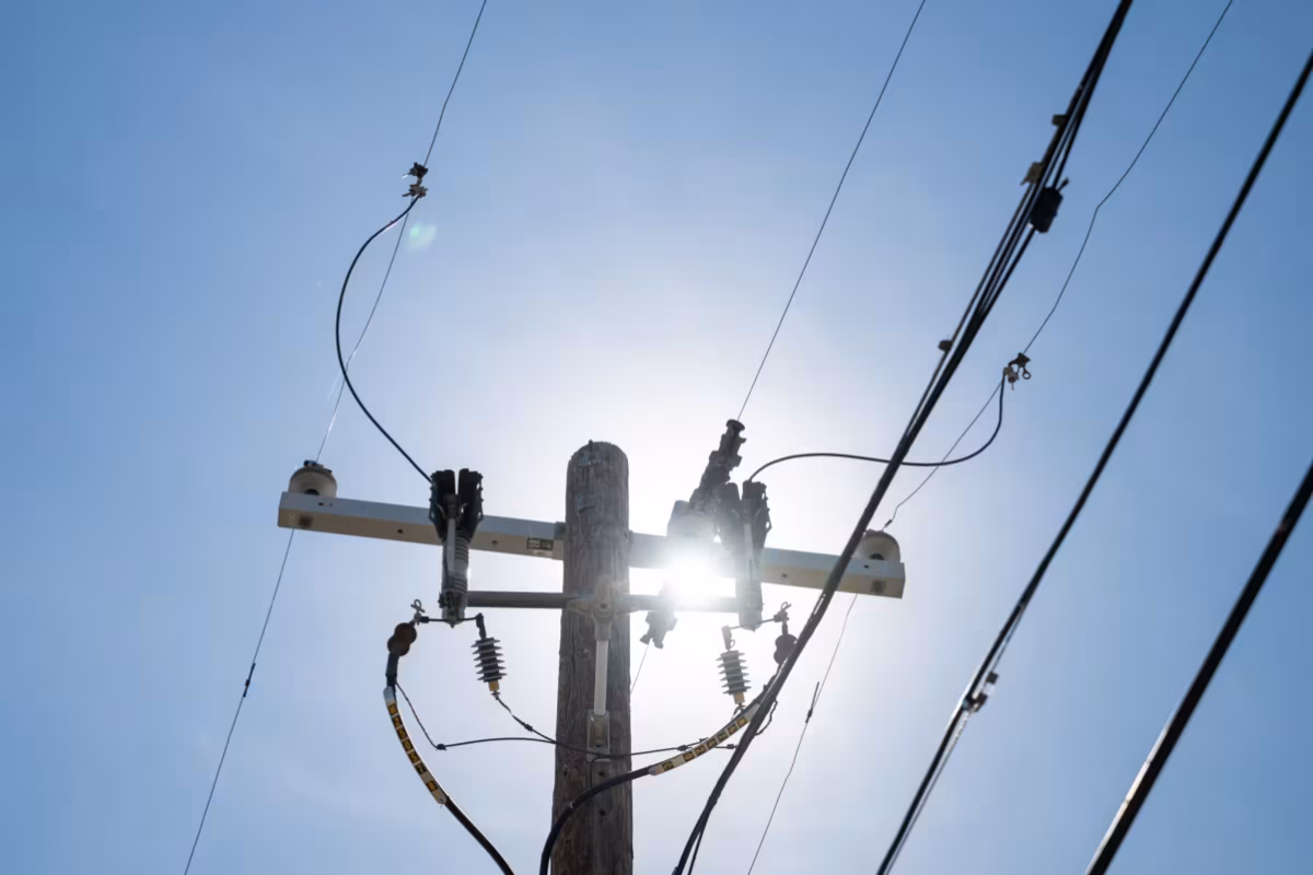 The sun shines through a power line during record-breaking heat in March in Tempe, Arizona