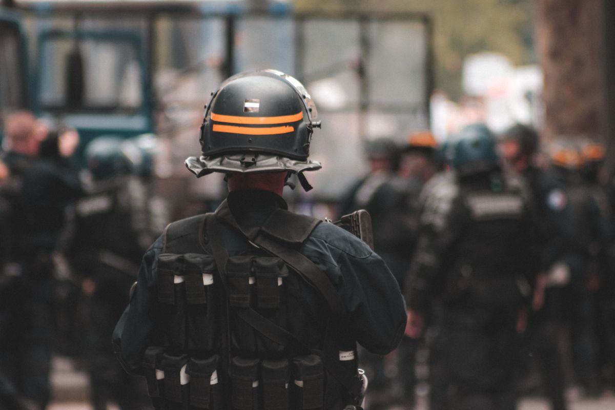 Axon Stock, Trump Trades, and ICE Contracts: A Market Story Driven by Timing, Trust, and Perception 2 Back view of anonymous policeman in helmet and bulletproof vest maintaining law and order while standing on city street