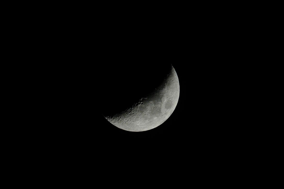 Darkness Killed the Dinosaurs: How a 66-Million-Year-Old Asteroid Starved the Oceans. 2 Capture of a crescent moon with detailed surface against a black sky background.
