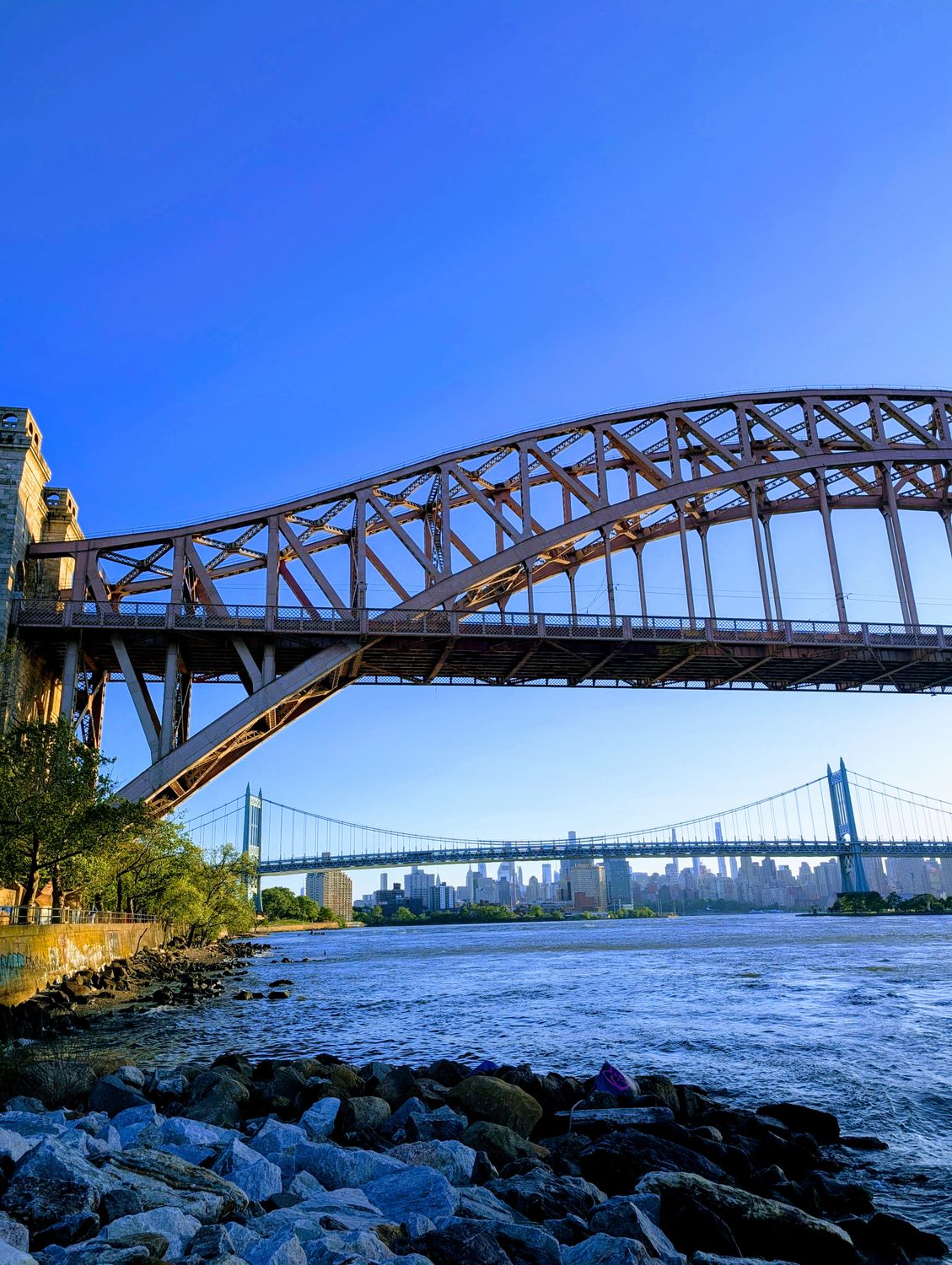 Capture of Hell Gate and RFK bridges with New York City skyline in the backdrop.