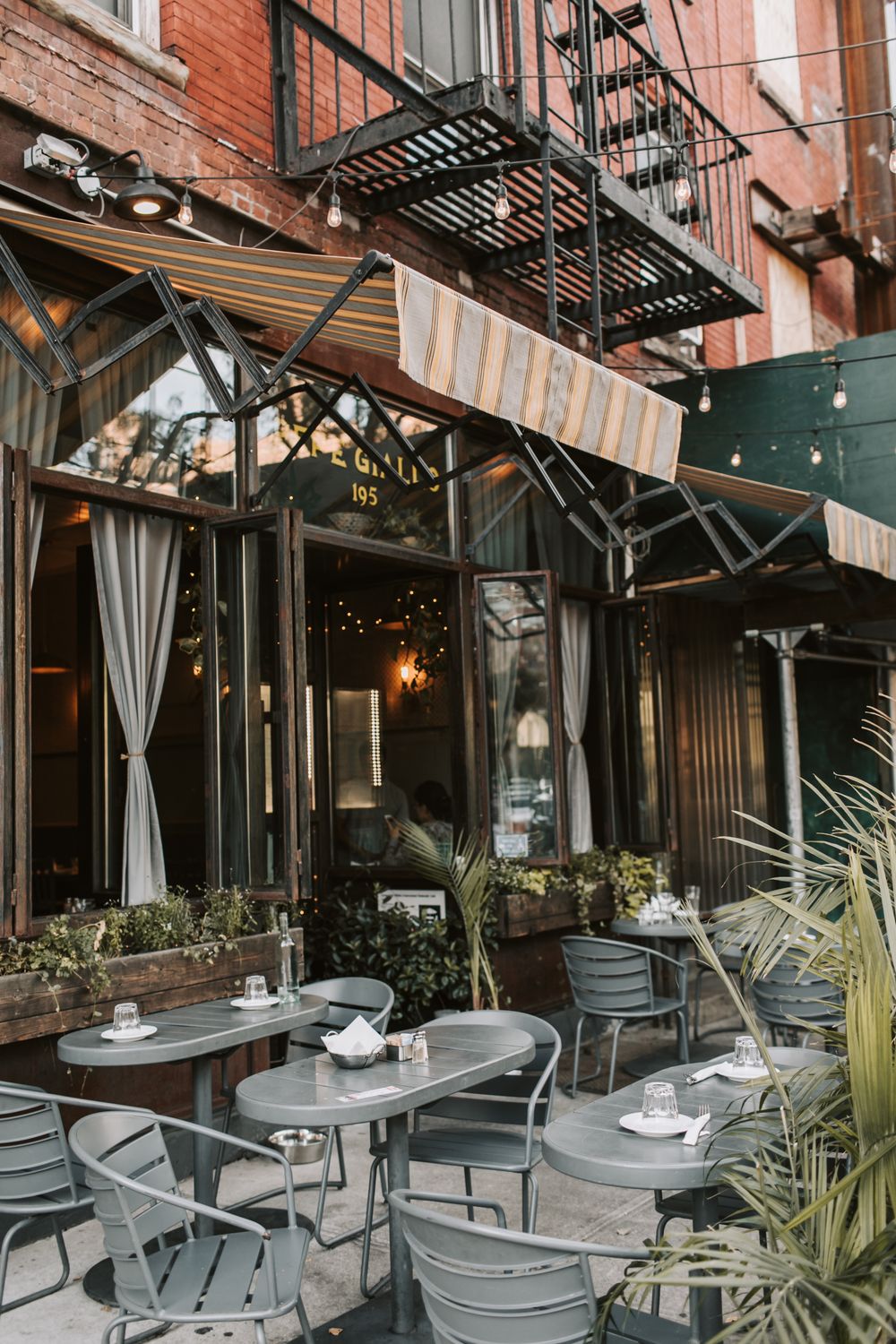 NYC and New Jersey’s Ultimate Food Scene: Where Every Bite Tells a Story 2 Charming café with outdoor seating in New York, featuring elegant design and city vibes.