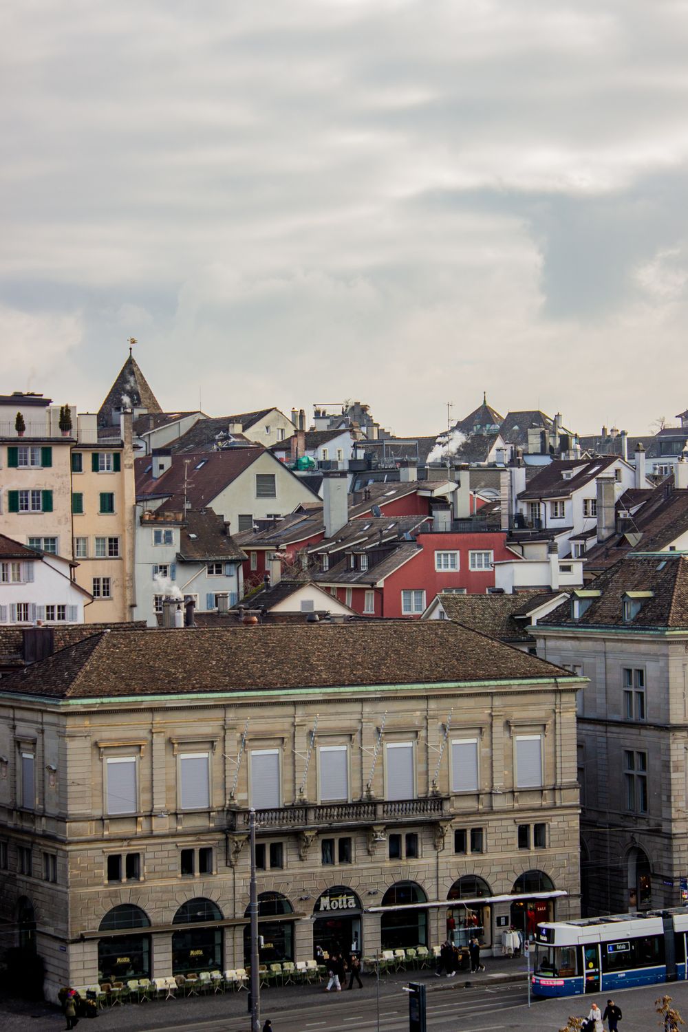 Everyone Wants to Move to Canada… But the Reality Is Not What You Expect 4 Charming view of Zurich's old town with classic European architecture under a cloudy sky.