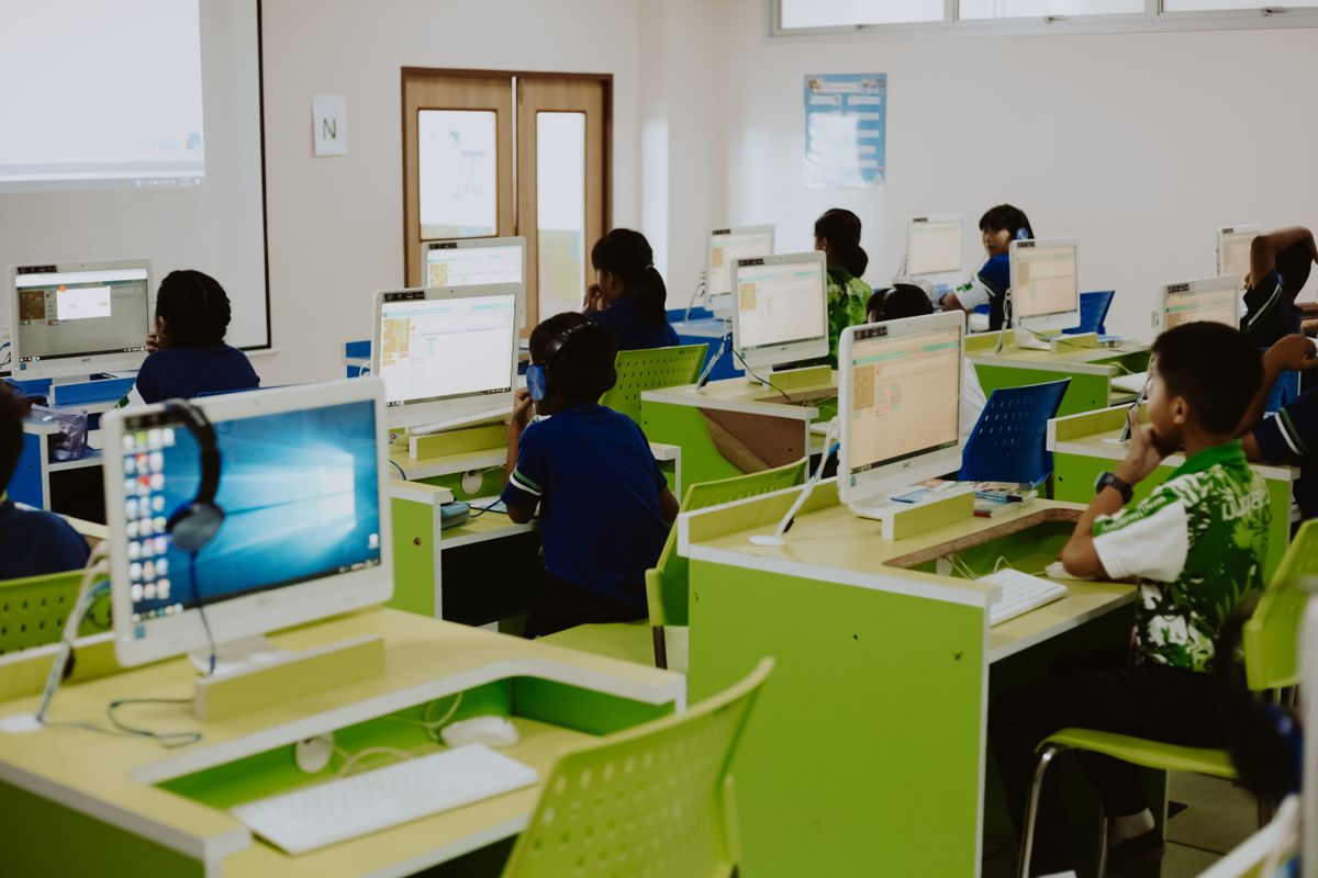 Writing Instruction for Students With Learning Problems Is Still Falling Short in Too Many Classrooms 3 Children learning in a modern computer lab environment with headphones and desktops.