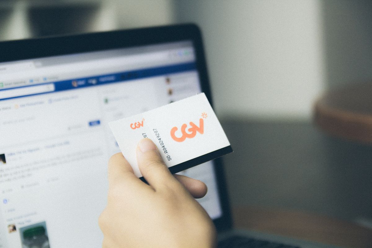 Six shocking fraud cases from 2024 show how fast money, trust, and technology can be turned against ordinary people. 3 Close-up of a hand holding a card near an active laptop screen, indoors.