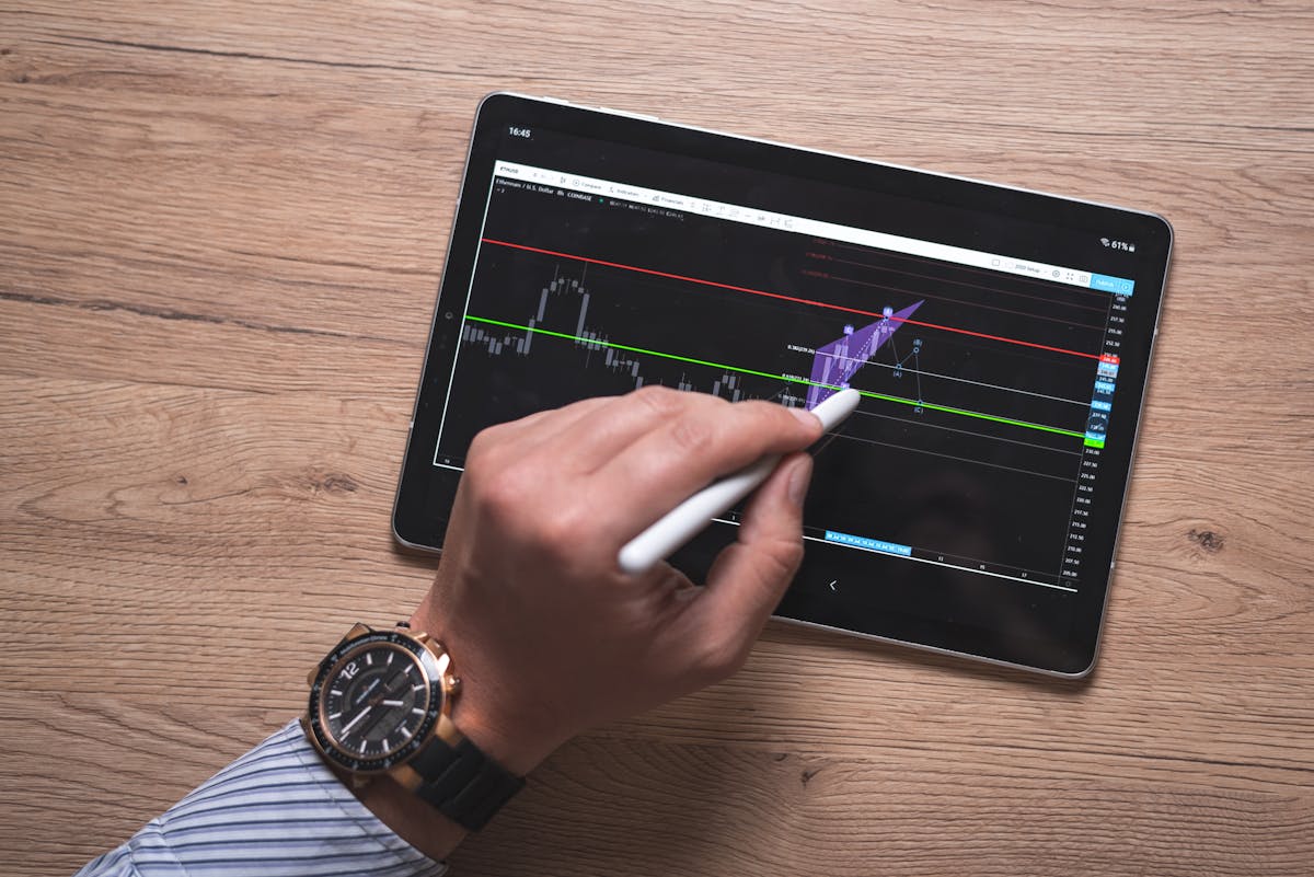Chicago Home Prices Jump 7.7% as Buyers Face a Hotter Than Expected Market. 2 Close-up of a hand using a stylus on a digital trading app on a tablet indoors.