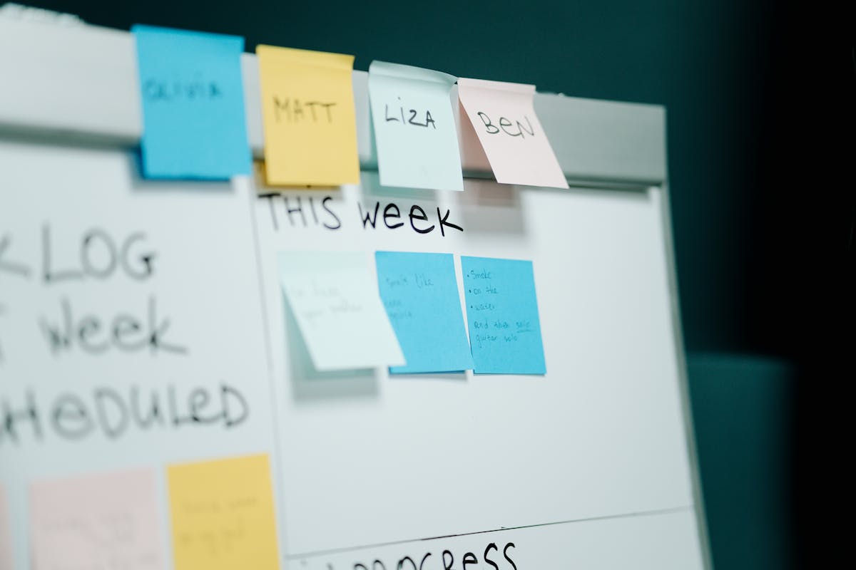 Brutally Relatable Things That Take Over ADHD Homes 2 Close-up of a whiteboard with colorful sticky notes for task organization and planning.