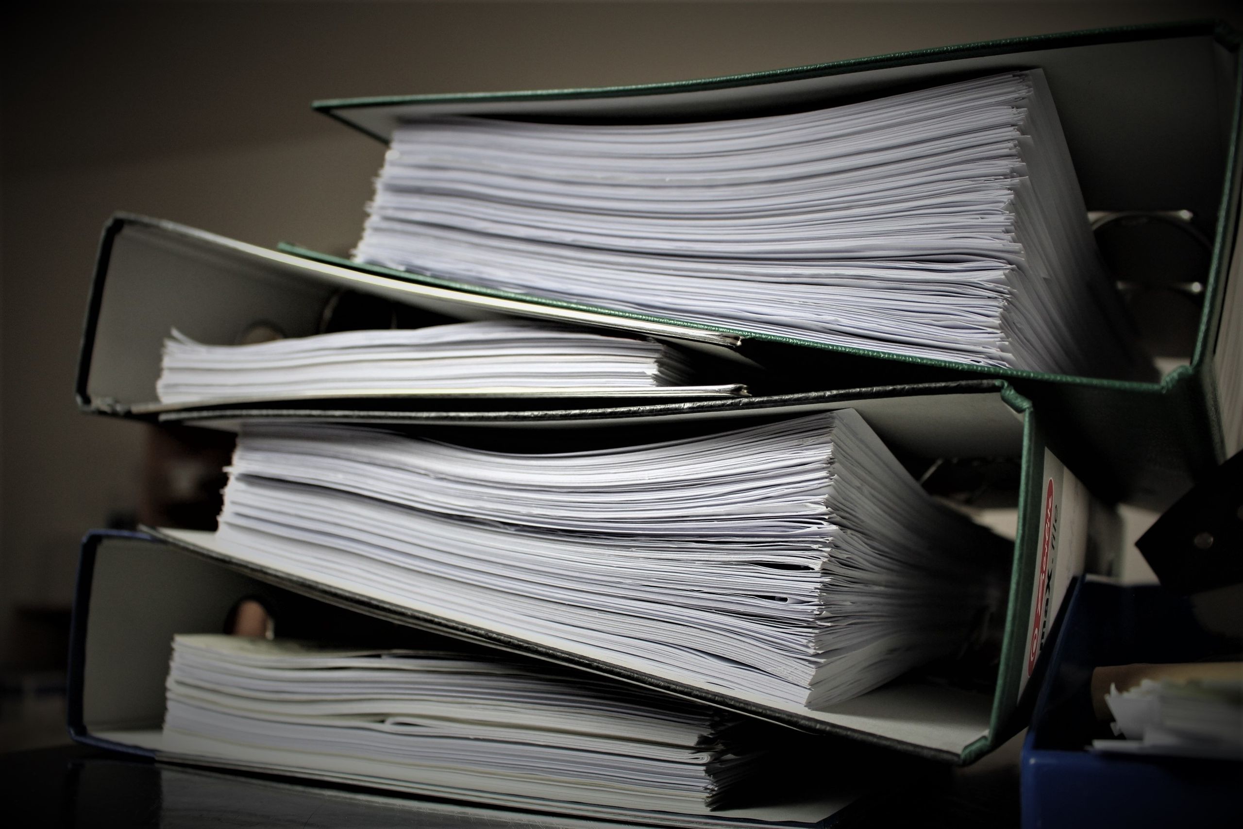 9 Reasons Florida’s ICE Surge Is Turning Routine Stops Into a Bigger Trust Fight 2 Close-up of stacked binders filled with documents for office or educational use.