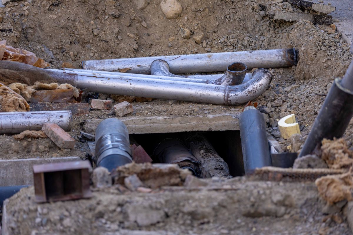 Del-Co Water Outages Update: Crews Respond to Emergency Repairs and Service Interruptions 2 Close-up of urban pipe installation at a construction site, showing various pipes and materials.