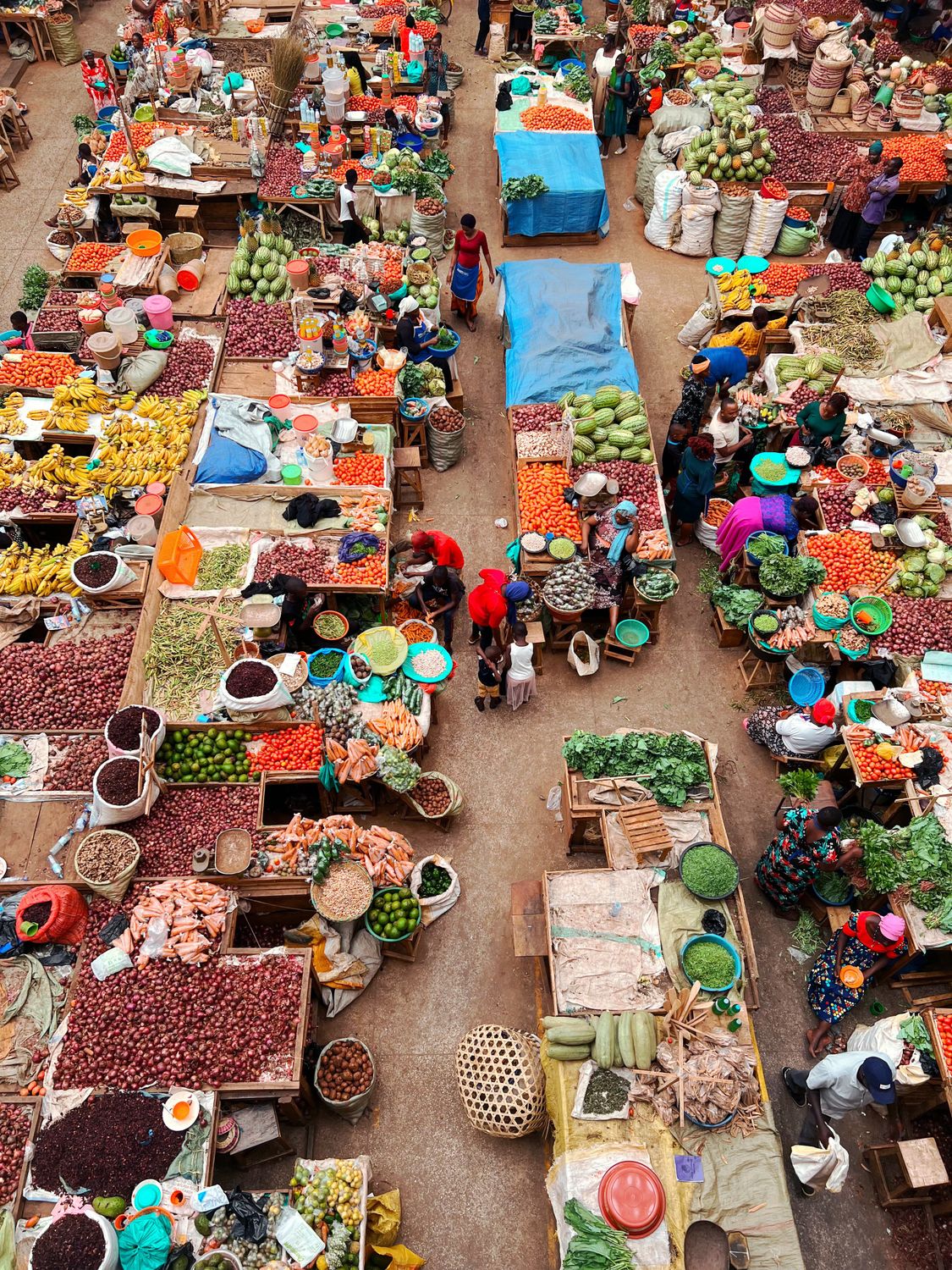 Colorful aerial photo capturing a busy food market with diverse fresh produce and market stalls.