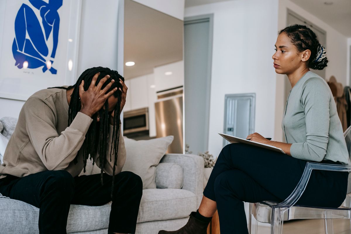 You’re Slowly Ruining Your Life by Ignoring These 9 Lifestyle Habits 2 Concentrated African American female psychotherapist in formal wear sitting on chair and consulting desperate male touching head in frustration